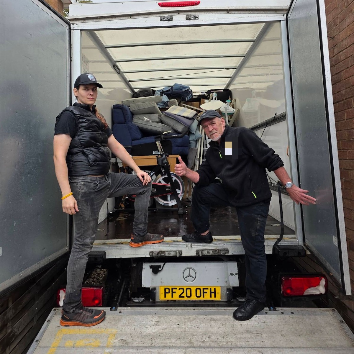 Ilja and a second mover standing at the back of his loaded Luton van, tail lift down
